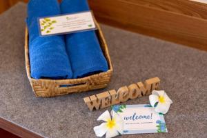 a welcome sign and a towel and flowers on the floor at Palm Coco Mantra in Lamai