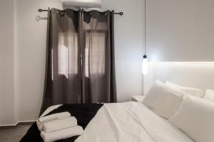 a bedroom with a bed with towels on it at Emfasis Loft Spacious and Elegant Heraklion in Heraklio Town