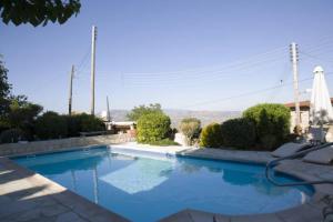 a large blue swimming pool in a house at Agrotiko Traditional Houses in Kallepia