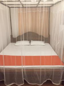 Postel nebo postele na pokoji v ubytování New Toropi Homestay