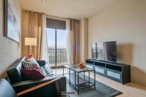 a living room with a couch and a flat screen tv at Alcam Sant Adria in Sant Adria de Besos