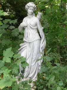 a statue of a woman holding a cross at Manoir de la Marjolaine in Cabourg