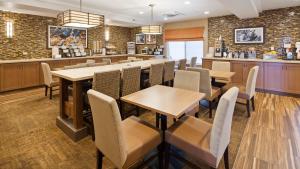 アイダホフォールズにあるベスト ウエスタン プラス コットンツリー インのテーブルと椅子のあるレストラン、バー