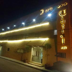 a building with a neon sign on the side of it at Hotel Central in San Luis Potosí