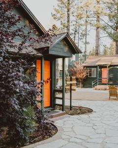 a house with an orange door next to a patio at Noon Lodge in Big Bear Lake