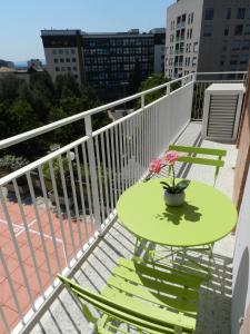 a green table and chairs on a balcony at Appartamenti Via Cortonese 1 in Perugia
