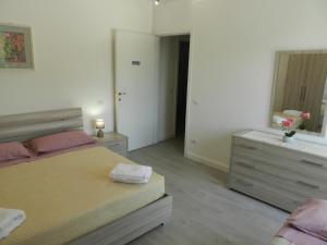 a bedroom with a bed and a dresser and a mirror at Appartamenti Via Cortonese 1 in Perugia