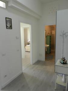 a living room with white walls and a hallway at Appartamenti Via Cortonese 1 in Perugia +39 photos