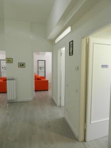 an empty hallway with an orange couch in a room at Appartamenti Via Cortonese 1 in Perugia