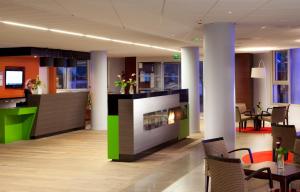 a lobby with a fireplace in a building at Escale Oceania Pornichet La Baule in Pornichet