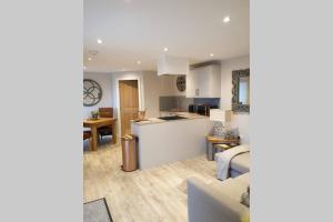 a kitchen and living room with a couch and a table at Luxury five star cottage one 