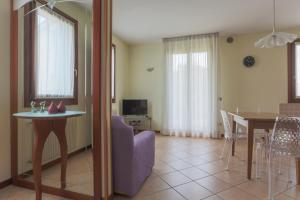 a living room with a table and a dining room at Hotel Ristorante al Gabbiano in Ponte di Piave