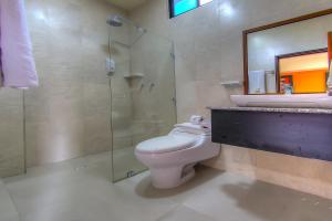 a bathroom with a toilet and a sink and a shower at Hotel San Vicente Galapagos in Puerto Villamil