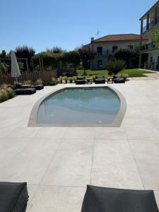 a swimming pool in the middle of a patio at Nostos Hotel in Afitos