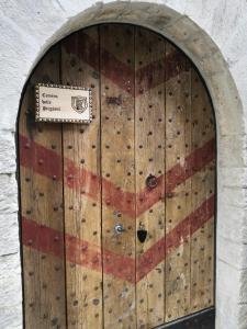Una porta di legno con una bandiera americana sopra. di Agriturismo Castello Di Belforte a Todi