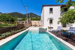 a pool in the backyard of a house at Villa Skyphos in Ammoudari