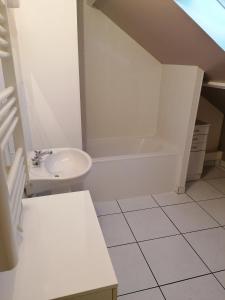 a white bathroom with a sink and a bath tub at Le sacré cœur bis -duplex 5pl in Le Havre
