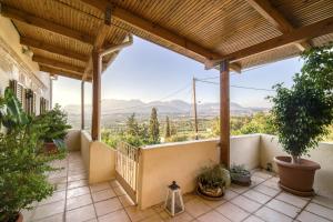a balcony with a view of the mountains at Serenity View - traditional village apartment in Kousés