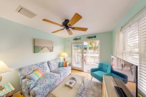 a living room with a couch and a ceiling fan at Shipyard Seaclusion in Key West