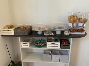 a shelf with pastries and other food items on it at B&b Cefalù in Cefalù