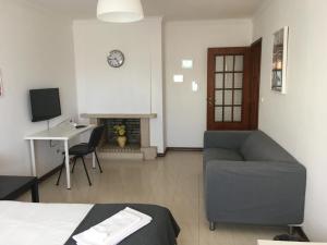 a living room with a couch and a table and a fireplace at APARTAMENTO LISBOA - REBOLEIRA in Amadora