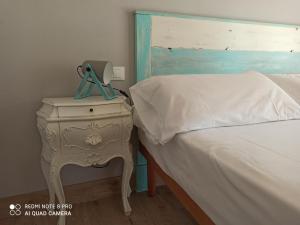 a bedroom with a bed and a nightstand with a side table at Villa Maddalena in Bardolino