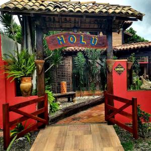 a gazebo with a sign that reads hotel at Pousada Holú in Itaúnas