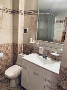een badkamer met een wastafel, een toilet en een spiegel bij Domek letniskowy Grodek in Gródek Nad Dunajcem