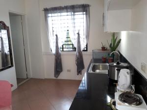 a kitchen with a sink and a window at Rent! Monthly or More in San Juan