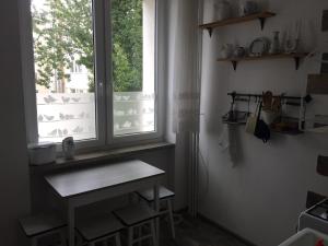 a kitchen with a window and a wooden table at Jednopokojowe mieszkanie w centrum Gdyni in Gdynia