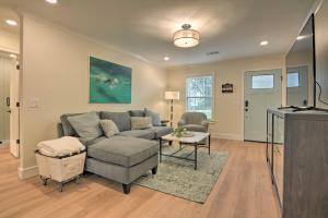 a living room with a couch and a table at Newly Remodeled House Less Than 1 Mi to Dtwn Bentonville! in Bentonville