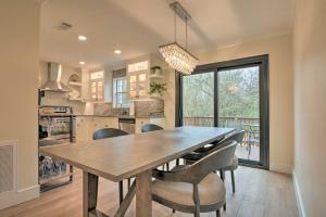 a kitchen and dining room with a wooden table and chairs at Newly Remodeled House Less Than 1 Mi to Dtwn Bentonville! in Bentonville