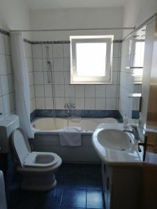 a bathroom with a tub and a toilet and a sink at Goga Apartments in Primošten +12 photos