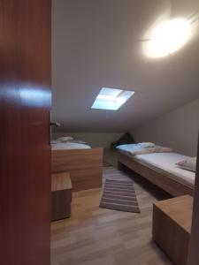 a room with two beds and a skylight at Guest accommodation house Greta in Tribunj