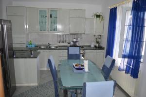 a kitchen with a table with a bowl of fruit on it at Goga Apartments in Primošten