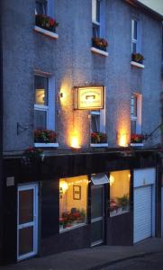 a building with a sign on the side of it at Inishross House in New Ross