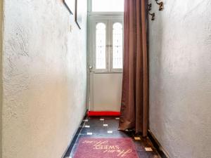 a hallway with a door with a window and a red rug at Town house with view over the 3 towers of Bruges in Bruges