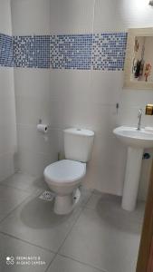 a bathroom with a toilet and a sink at BEIRA MAR APTO 711 in Ubatuba