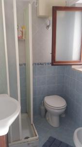 a bathroom with a toilet and a sink at Alba Sea House in Alcamo Marina