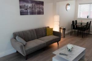 a living room with a couch and a table at Gorgeous ground floor apartment + free parking in Manchester