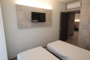 A bed or beds in a room at Persea mare appartamenti