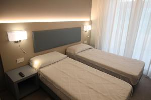 A bed or beds in a room at Persea mare appartamenti