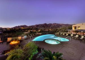 a swimming pool on a patio with a view of the mountains at Hacienda del Sol Guest Ranch Resort in Tucson