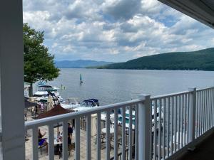 a balcony with a view of a lake with boats at The Georgian Resort in Lake George