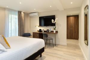 Postel nebo postele na pokoji v ubytování Best Western Plus Hôtel Brice Garden Nice