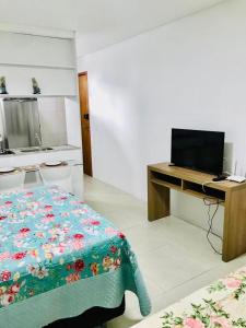 a bedroom with a bed and a desk with a computer at Golden Shopping Home Service in Recife