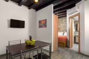 a room with a dining table and a bedroom at Apartments in the center marasia in Rhodes Town