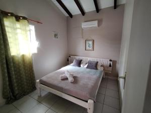 Postel nebo postele na pokoji v ubytování Ti Village Creole
