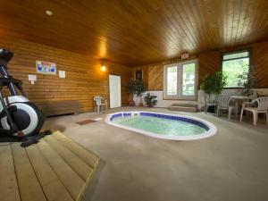 a large room with a swimming pool in a house at Chalet Continental Motel in Valemount