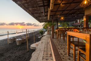 a restaurant on the beach with a view of the ocean at Amed Beach Resort in Amed